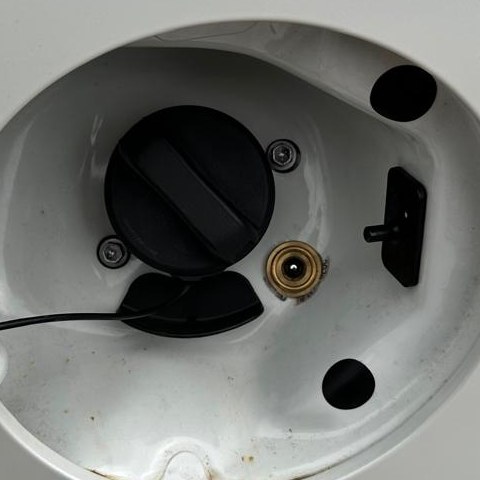 Behind one fuel flap: the petrol cap and the brass Autogas filler valve side by side